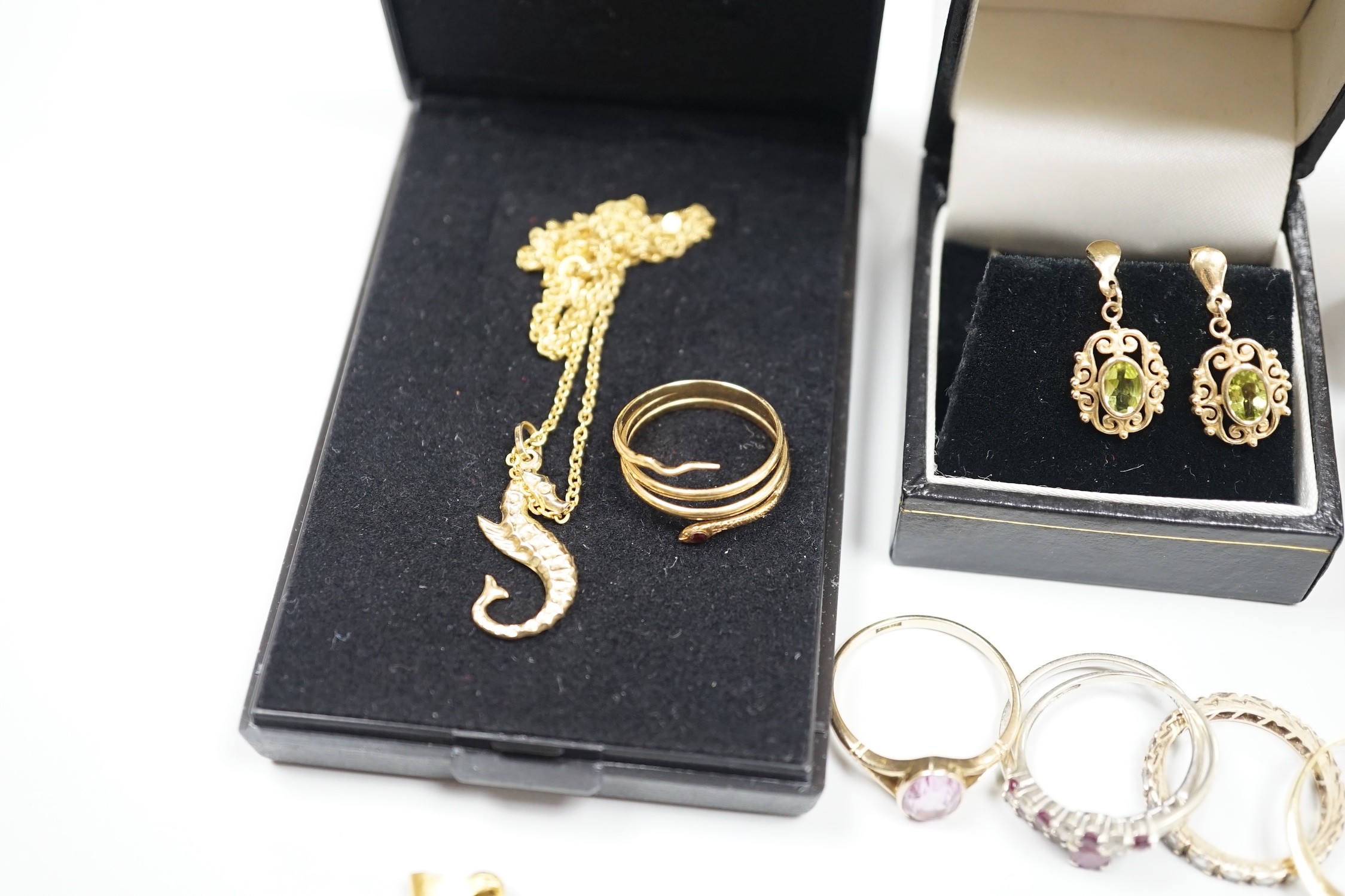 A small group of assorted modern jewellery including a 750 yellow metal and gem set serpent ring, gross 2.4 grams, a 15ct and gem set ring, gross 2.6 grams, a pair of 14k and gem set ear studs, gross 2.1 grams, a 585 sea